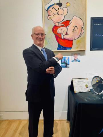 man standing in front of painting