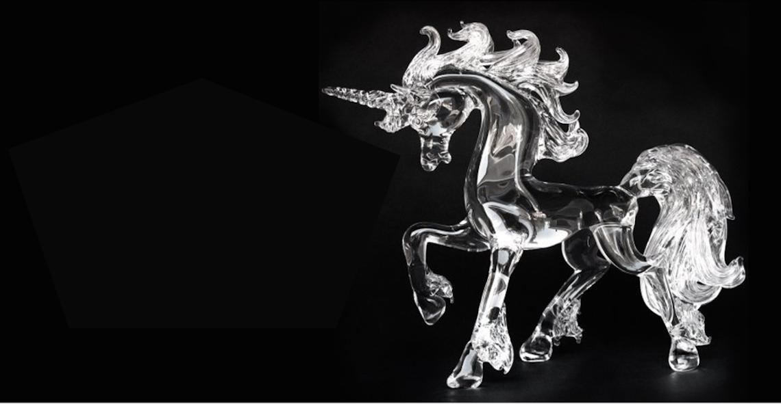 Glass unicorn sculpture on a black background from 