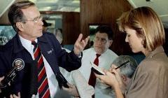 A man and woman in conversation inside an airplane cabin.