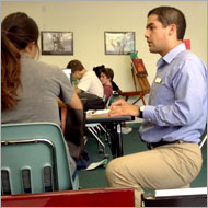 A lesson in a classroom with several students seated.