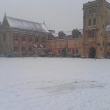 Snow-covered courtyard and historic buildings at Oxford University.