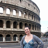 A person standing in front of the Colosseum in Rome.