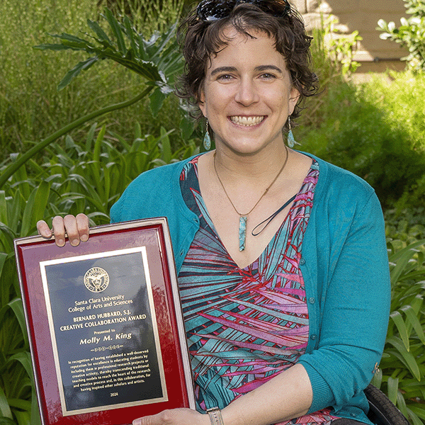 Molly King holding her award