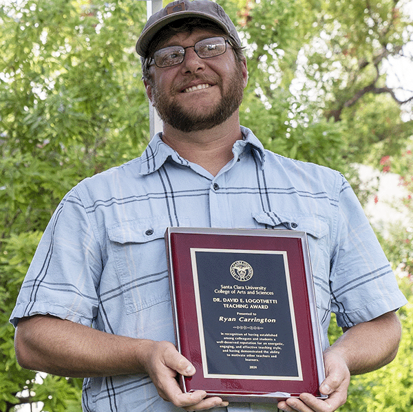 Ryan Carrington holding his award