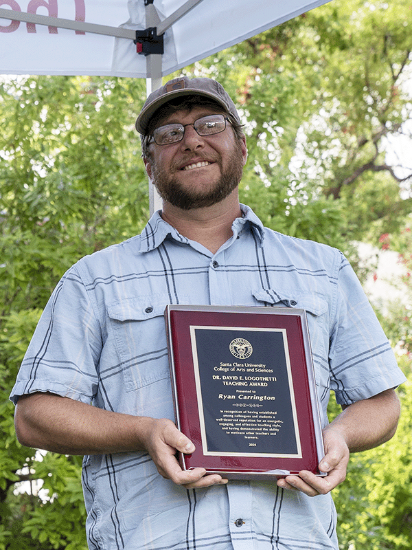 Ryan Carrington holding his award