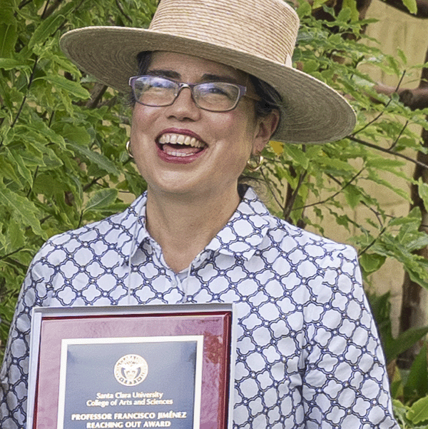 Sarita Tamayo-Moraga holding her award