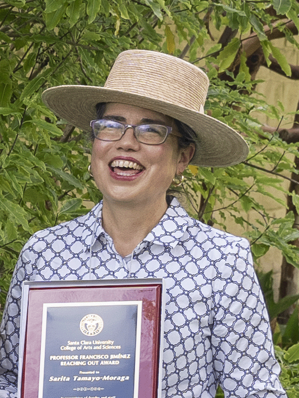 Sarita Tamayo-Moraga holding her award