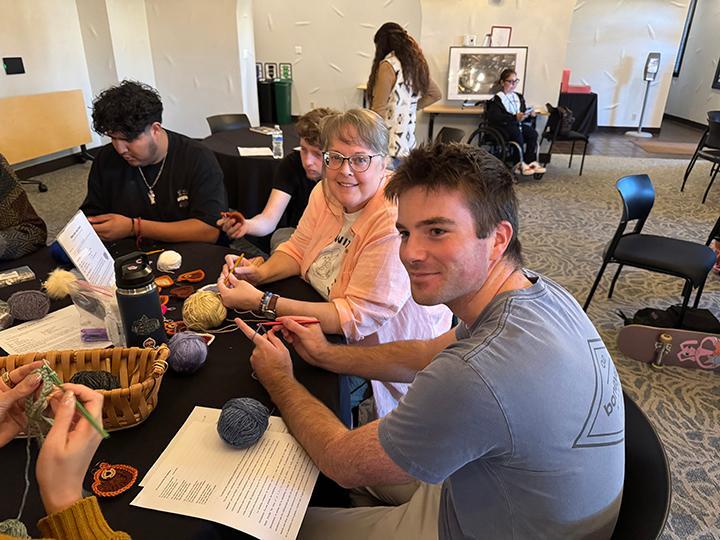 Students and faculty at a knitting project