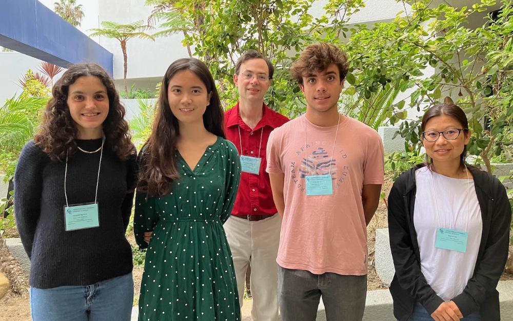 3 female and 2 male students at a conference