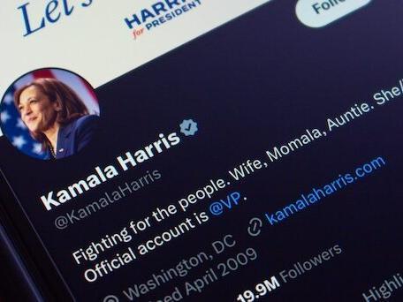 Kamala Harris' Twitter/X account feed on an iPhone screen