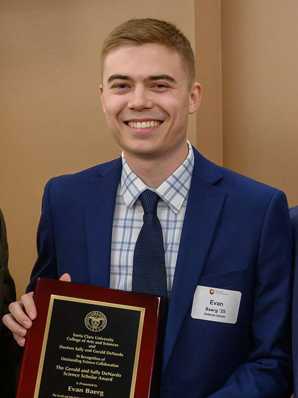 Evan Baerg holding the 2025 DeNardo Senior Prize award