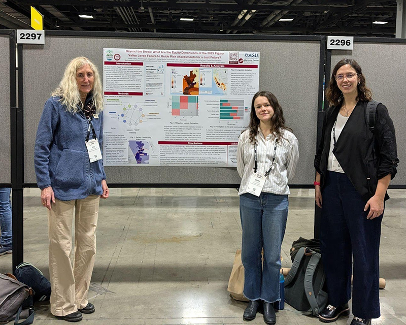 Iris Stewart-Frey and students standing next to a research poster.