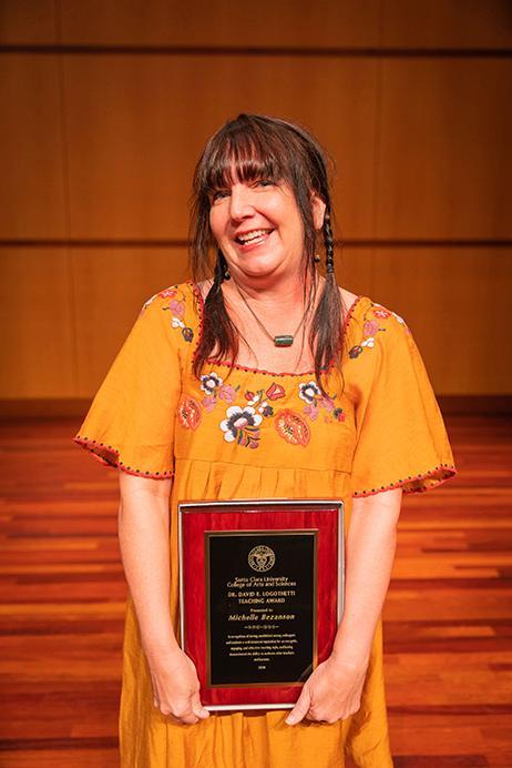 Michelle Bezanson holding award