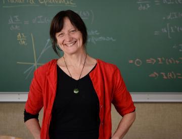 A person standing in front of a chalkboard.