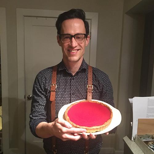 Travis Stevens holding cranberry curd tart