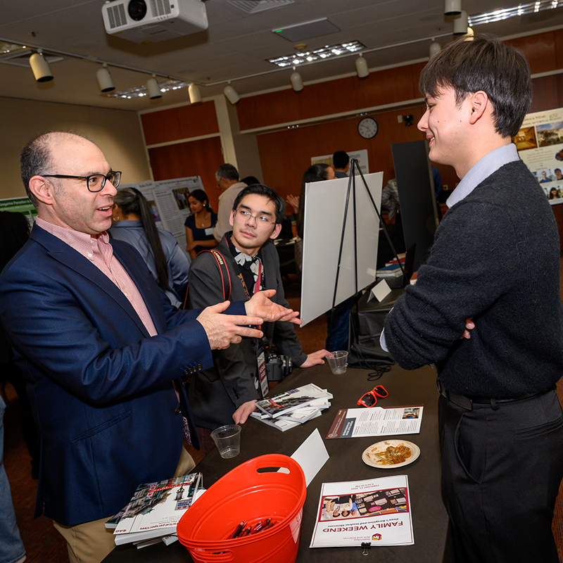 Samuel Cao discusses his presentation with Dan Turkeltaub