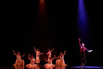 6 Greek muses in white kneeling and an artist with a paint brush held aloft