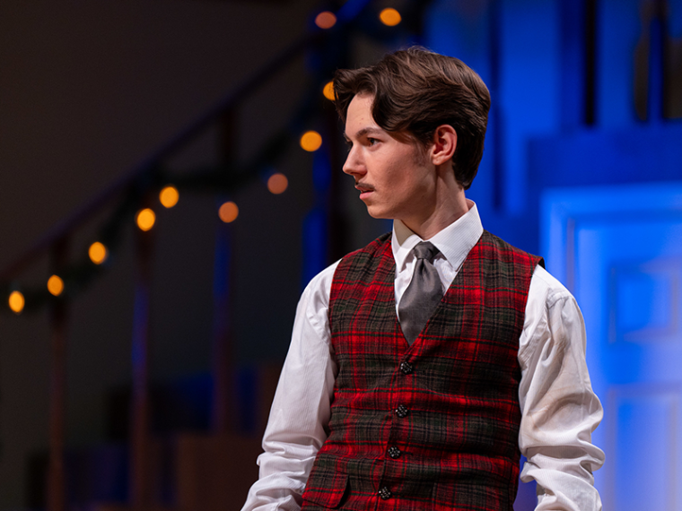 Christian Barnard in vest and tie on stage for the production of The Game's Afoot