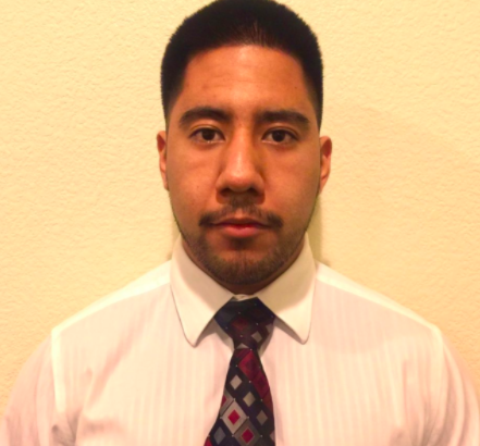 A man in a white shirt with a patterned tie.