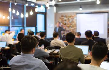 Audience Listens to Lecturer at a Conference Meeting Seminar Training.  Right 3-Adobe Stock