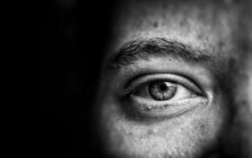 Close-up view of a human face showing just the eye and eyebrow. Image by Photo by Jose A.Thompson on Unsplash.