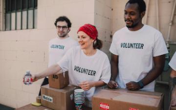 Three people wearing shirts that say 