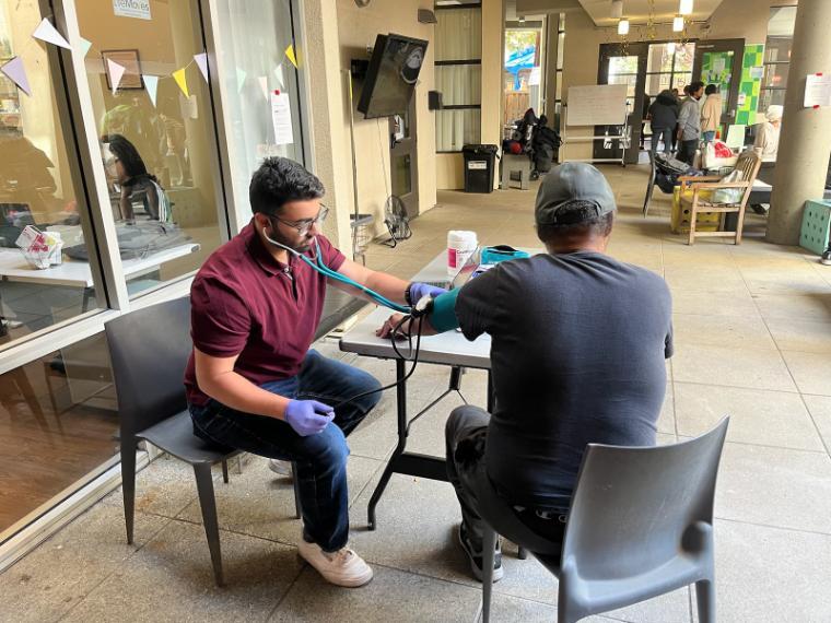 Bilal Arshadullah ’24, Health Equity and Innovation Fellow works with patient at the Opportunity Center Blood Pressure Clinic in Palo Alto, California in May 2025. Photo provided courtesy of Bilal Arshadullah.