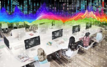 Students at computers with screens that include a representation of a retinal scanner with pixelation and binary data overlays and a brightly coloured datawave heatmap at the top.