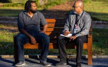 Gary Fields of the Associated Press, right, interviews Evan Milligan, left, on Sept. 19, 2022, in Montgomery, Ala. Milligan was among voters and advocacy groups who filed a lawsuit challenging the redistricting that split Montgomery between two congressional districts. (AP Photo/Vasha Hunt)