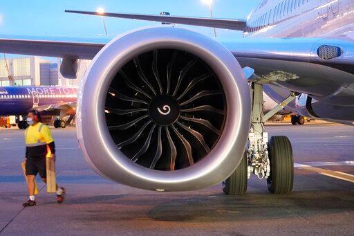 A ramp worker walks near one of two CFM International LEAP-1B engines on a Boeing 737-9 Max airplane Monday, March 1, 2021, at Seattle-Tacoma International Airport in Seattle. Photo by Ted S. Warren_AP Photo.