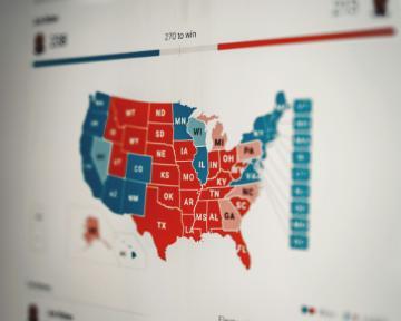 A map of the U.S. highlighted in red and blue. Photo by Clay Banks/Unsplash.