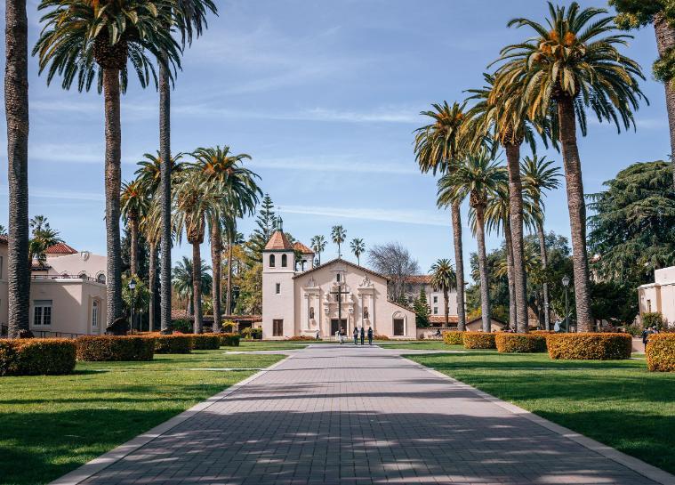 The mission church on campus flanked by palm trees