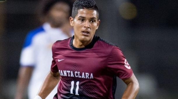 A soccer player wearing a maroon jersey numbered 11, running during a match