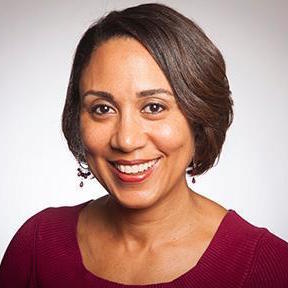 A person smiling in a professional headshot.