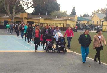 Group of people walking around a field at Washington Elementary School.