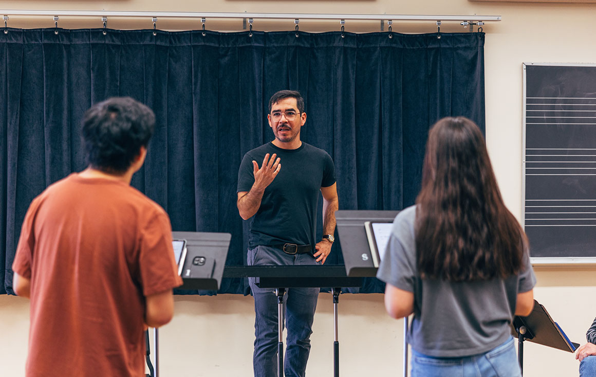 Nicolas Benavides teaches students in music classroom.