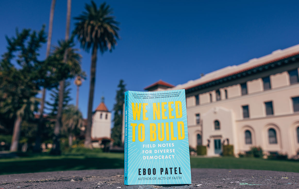 The book selected for this year's Community Read sits in front of campus buildings and palm trees.