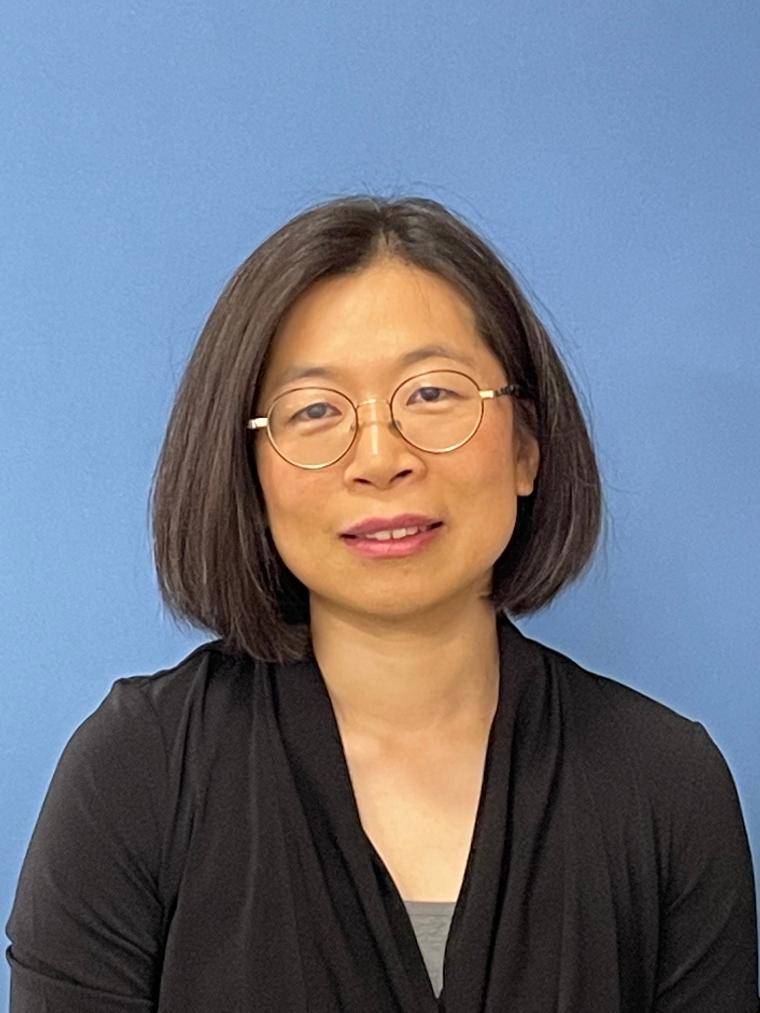 A person against a blue background.