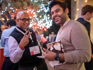 Two people laughing at Demo Day event