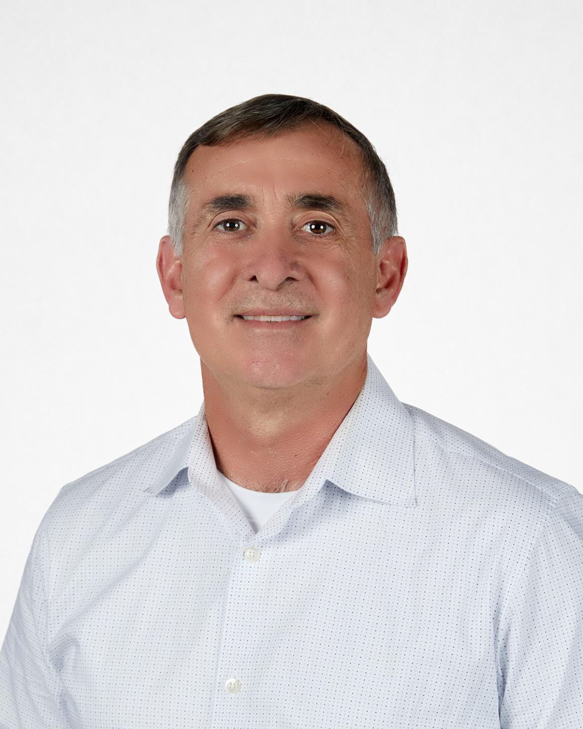 Man smiling in white collared shirt
