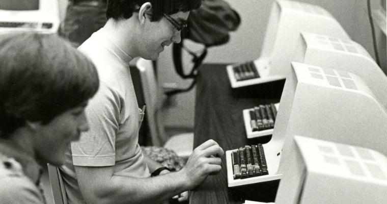 Students of the Leavey School of Business work on early computers.