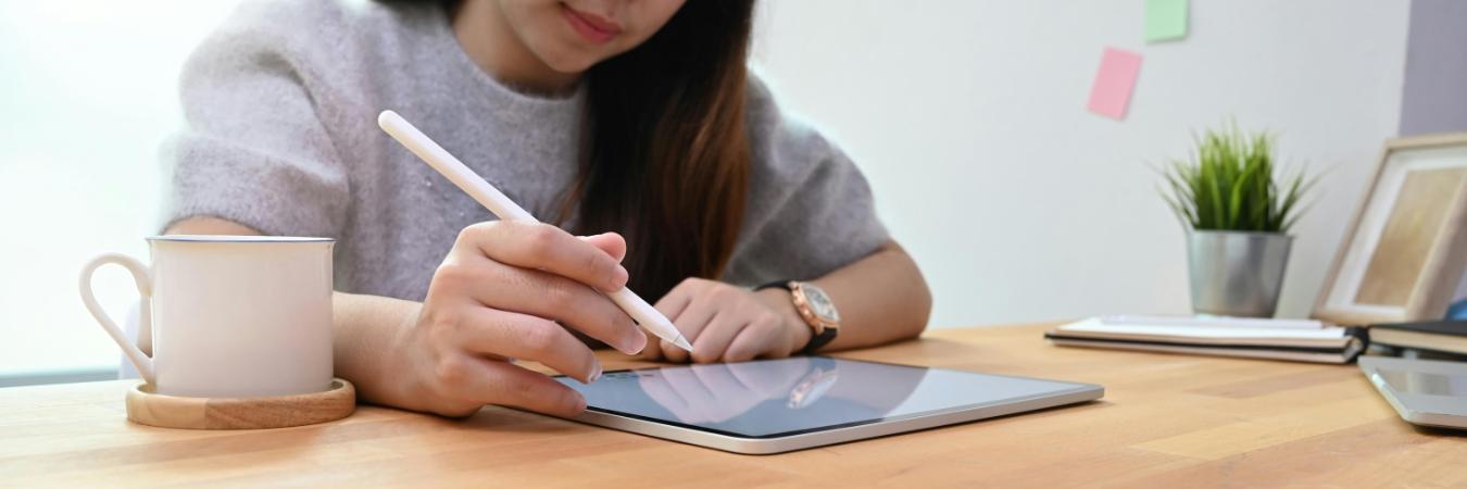 Young creative woman using stylus and tablet