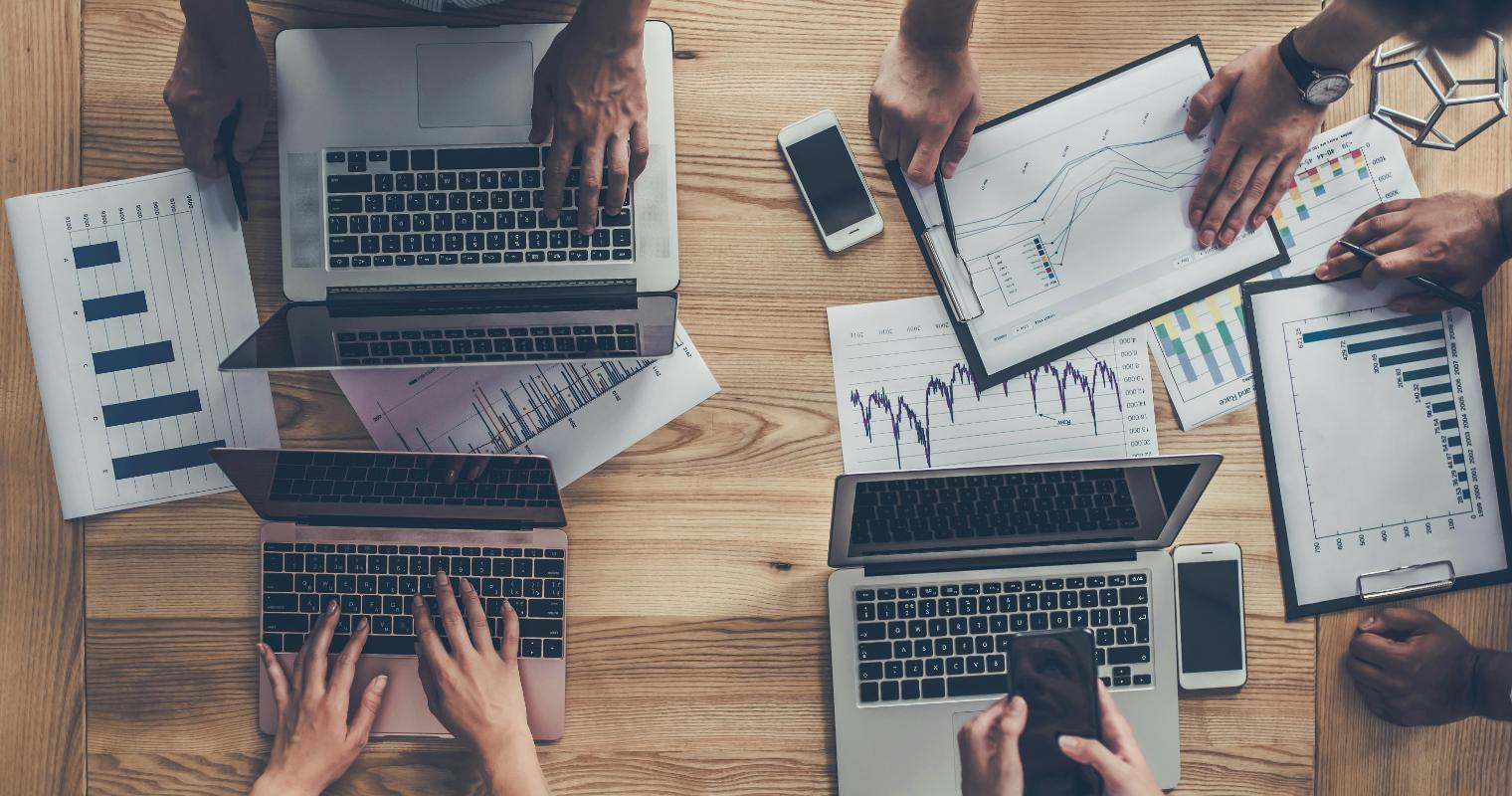 Professionals collaborating in a modern office, working with data.