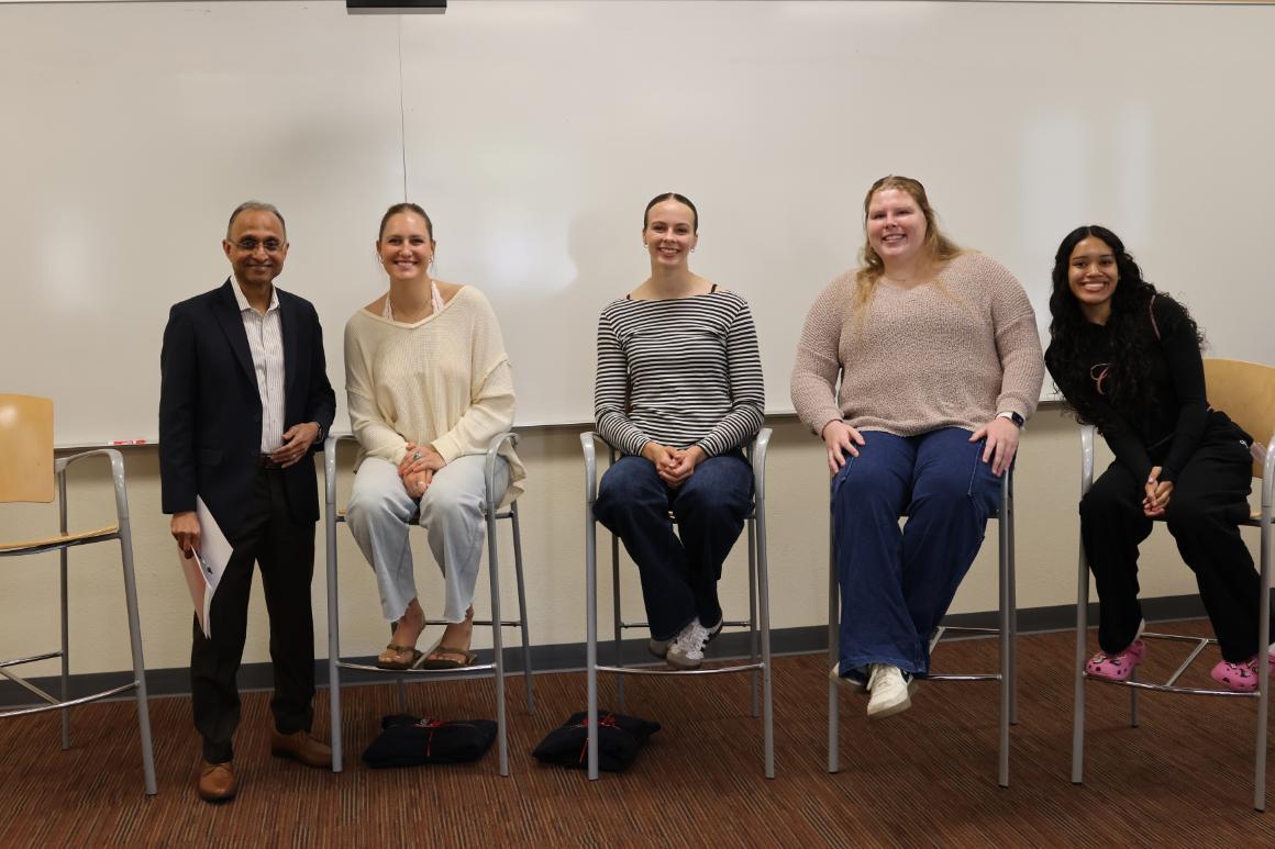 Group photo featuring four Leavey student athletes and Interim Dean Agrawal