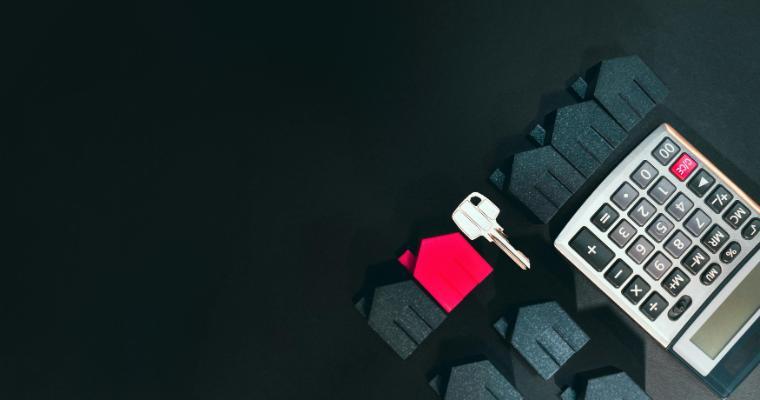 House-shaped models, a house key, and calculator image link to article