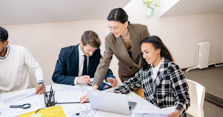 Finance professionals discussing charts image link to article