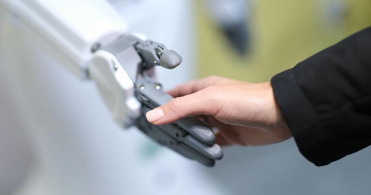 Human and robot handshake closeup image link to article