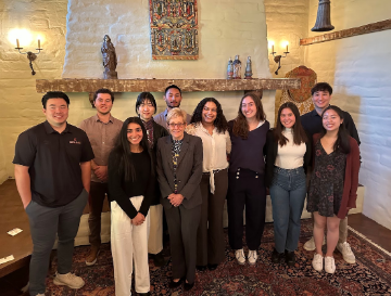 Group photograph titled 'LSB Fellows with SCU President' in a room with a fireplace.