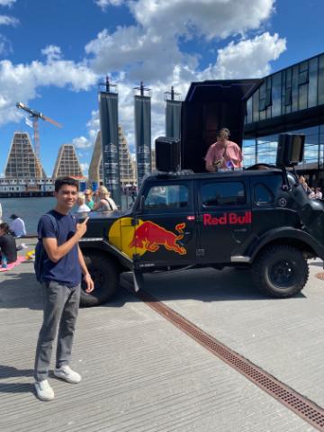 A person standing by a vehicle with a colorful design.