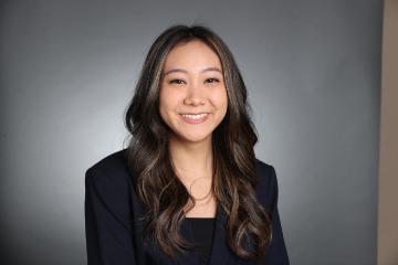 A person smiling in a professional portrait.